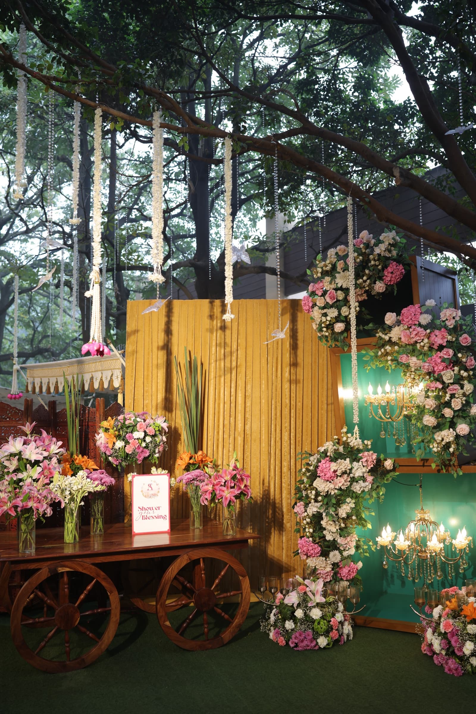 A gilded baroque mirror engraved 'Welcome to the reception' framed by lush florals